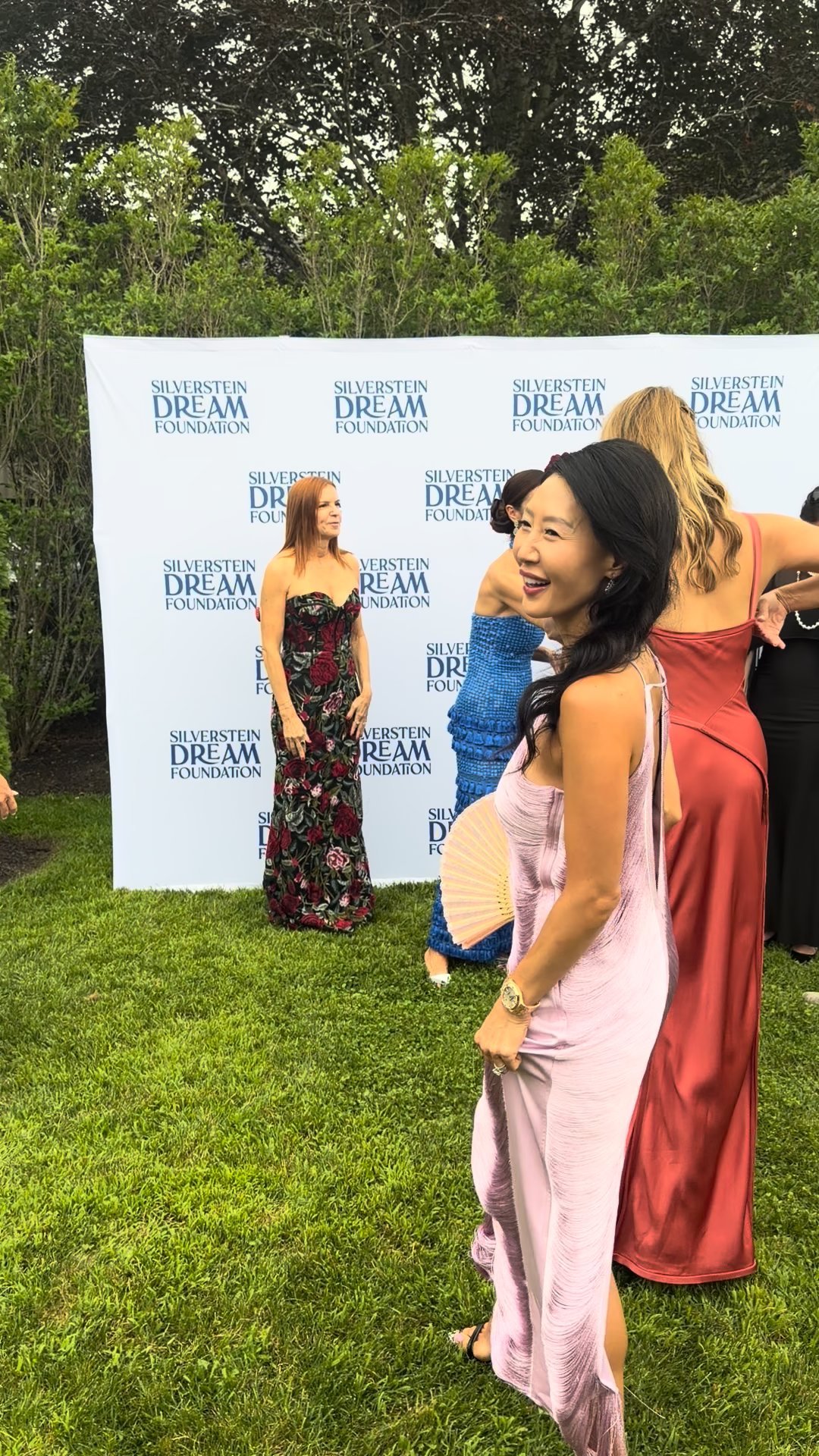 Guests against the foundation's DREAM boards.